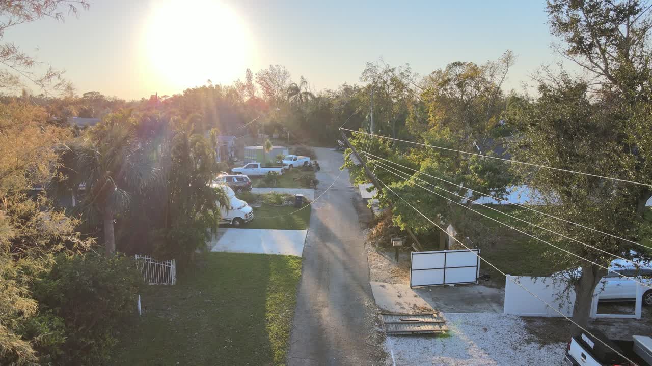 Roadside debris and broken power lines in Bradenton, Florida, after Hurricane Milton's impact. Crane Down