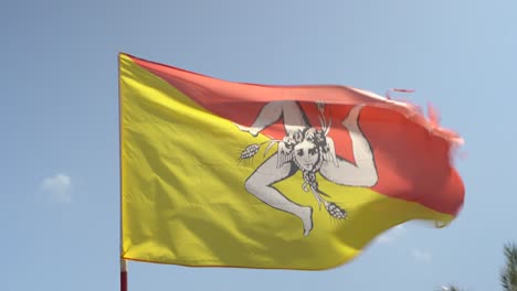 Wind-moving-the-flag-of-Sicily,-an-Italian-island-in-the-Mediterranean-Sea