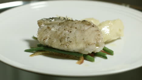 food presentation of steamed fish dish