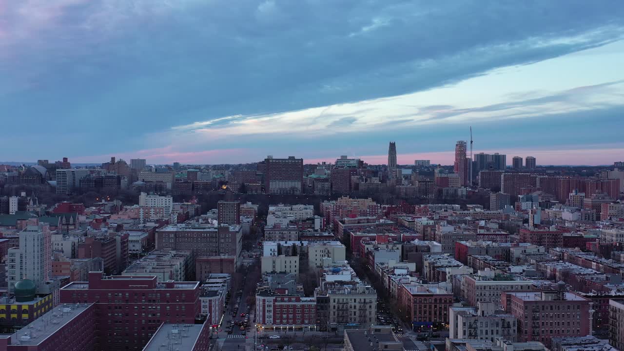 Short drone rise over New York City's Harlem neighborhood looking west towards Morningside Heights in the distance