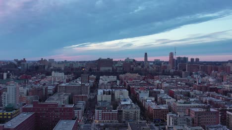 short drone rise over new york city's harlem neighborhood looking west towards morningside heights in the distance