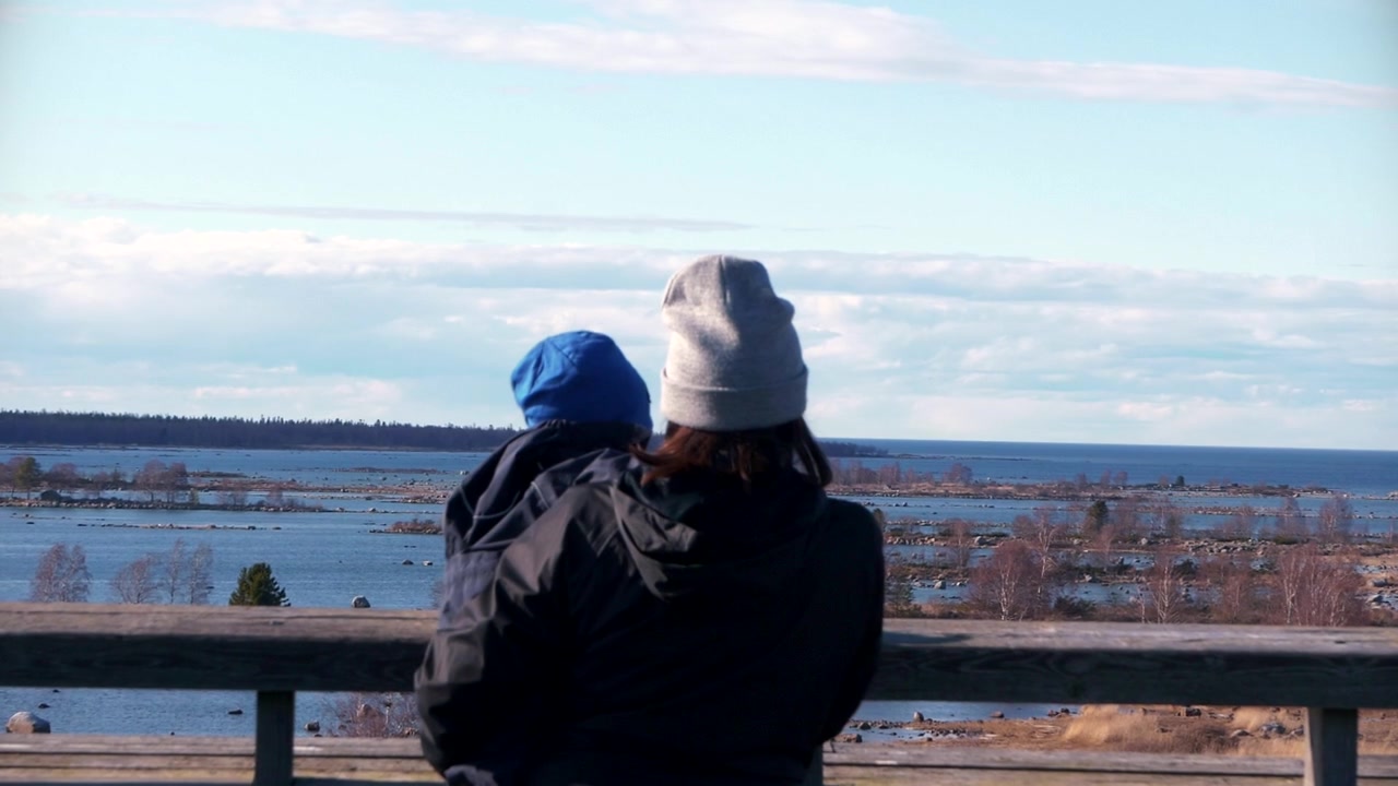 Mother and son in watchtower overlooking Unesco world heritage site in Kvarken archipelago with De geer Moraines