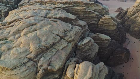 view from above of sandstone and granite rock formations in wadi rum desert, jordan