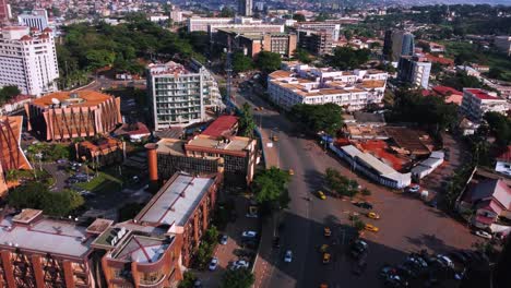 Flying-over-the-city-center-of-Yaounde,-sunny-Cameroon,-Africa---Aerial-view