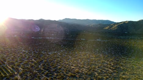 Drone-shot-sunrise-over-mountains-and-desert-in-Yucca-Valley-in-America