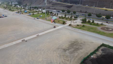 Drone-video-of-paraglider-or-trike-landing-in-Lima,-Peru