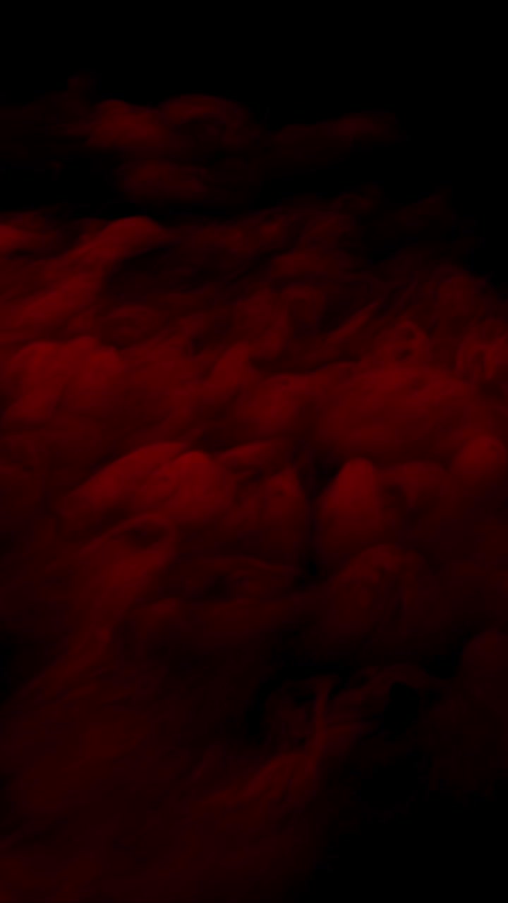 Vertical format thick dark red smoke or fog rolling heavily for dramatic or horror atmosphere