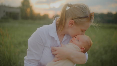 mother hugging baby at sunset