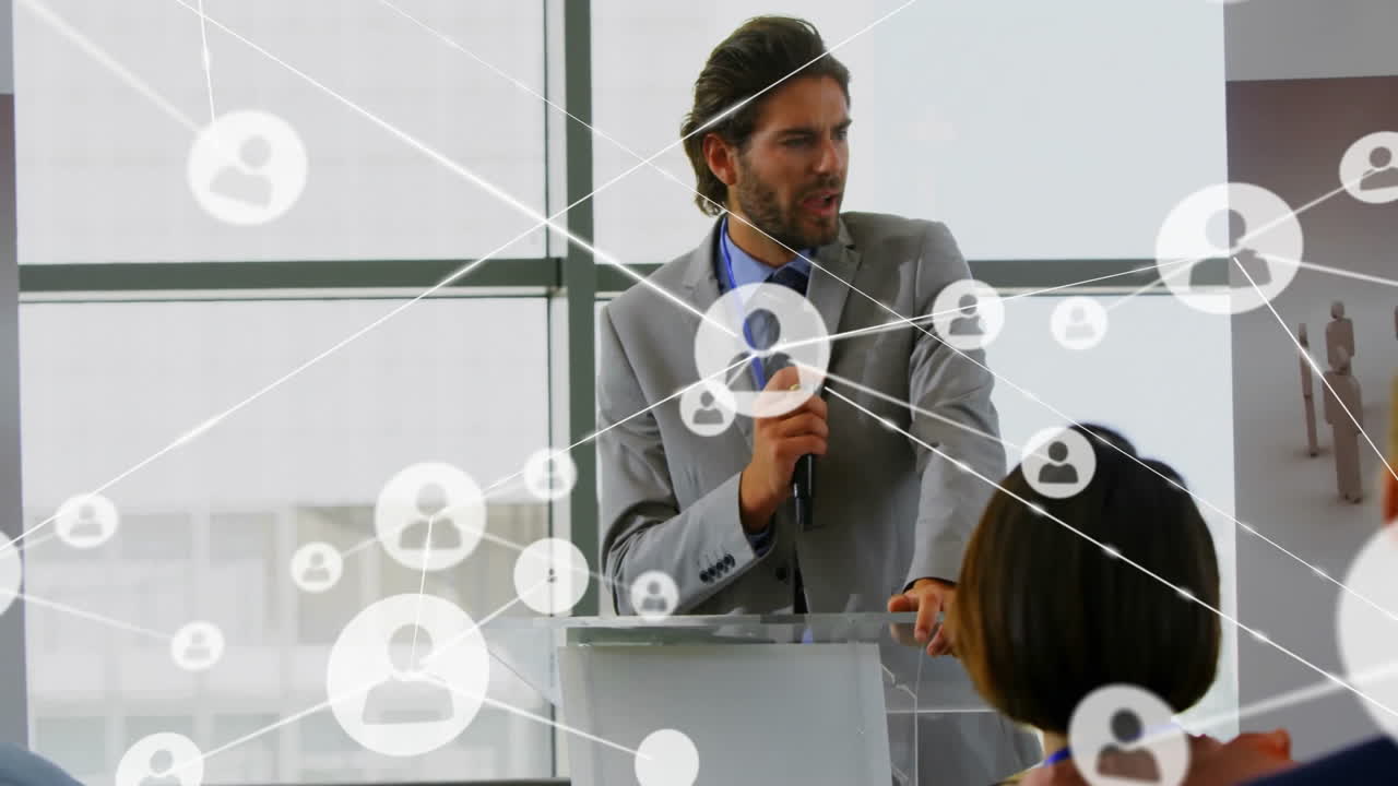 Animation of network of connections with icons over diverse colleagues at meeting in office