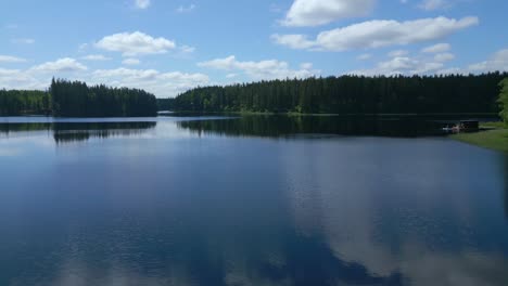 Boats-and-canoes-docked-at-pier-on-beautiful-lake-in-Swedish-nature