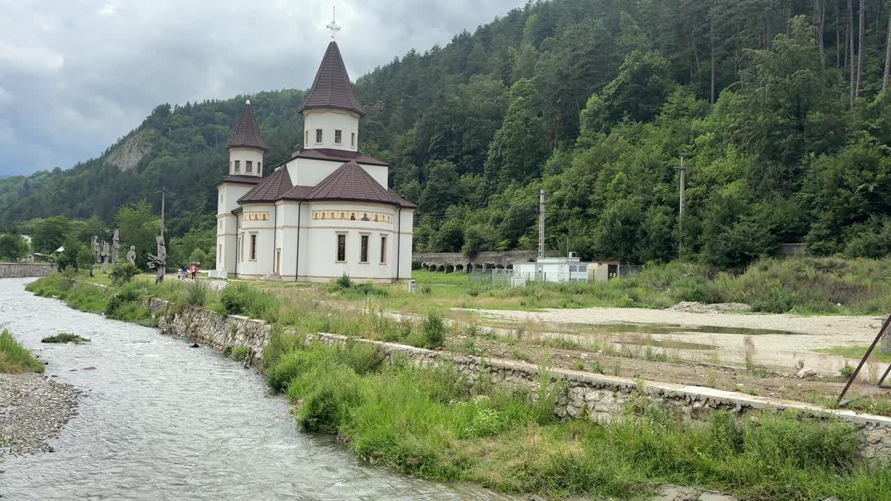 Bran orthodox church by a river in rural Transylvania