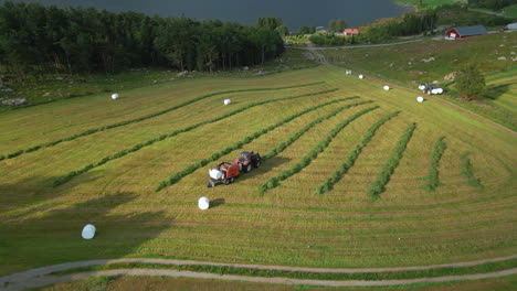 tractors collect foliage crops for silage, and make plastic wrapped bales, aerial