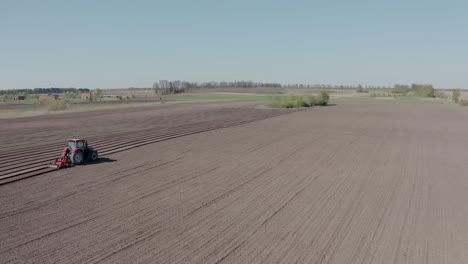 the tractor prepares the soil for planting. agricultural machinery.