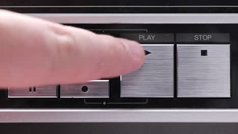 extreme close up of buttons on an old antique or vintage vcr pushing the play button a bunch of times or aggressively