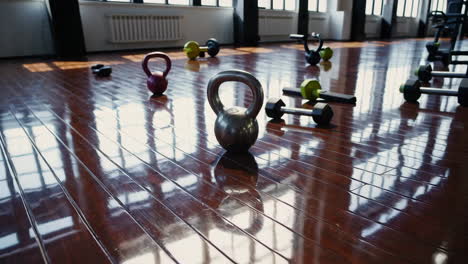 kettlebell and dumbbells on wooden floor