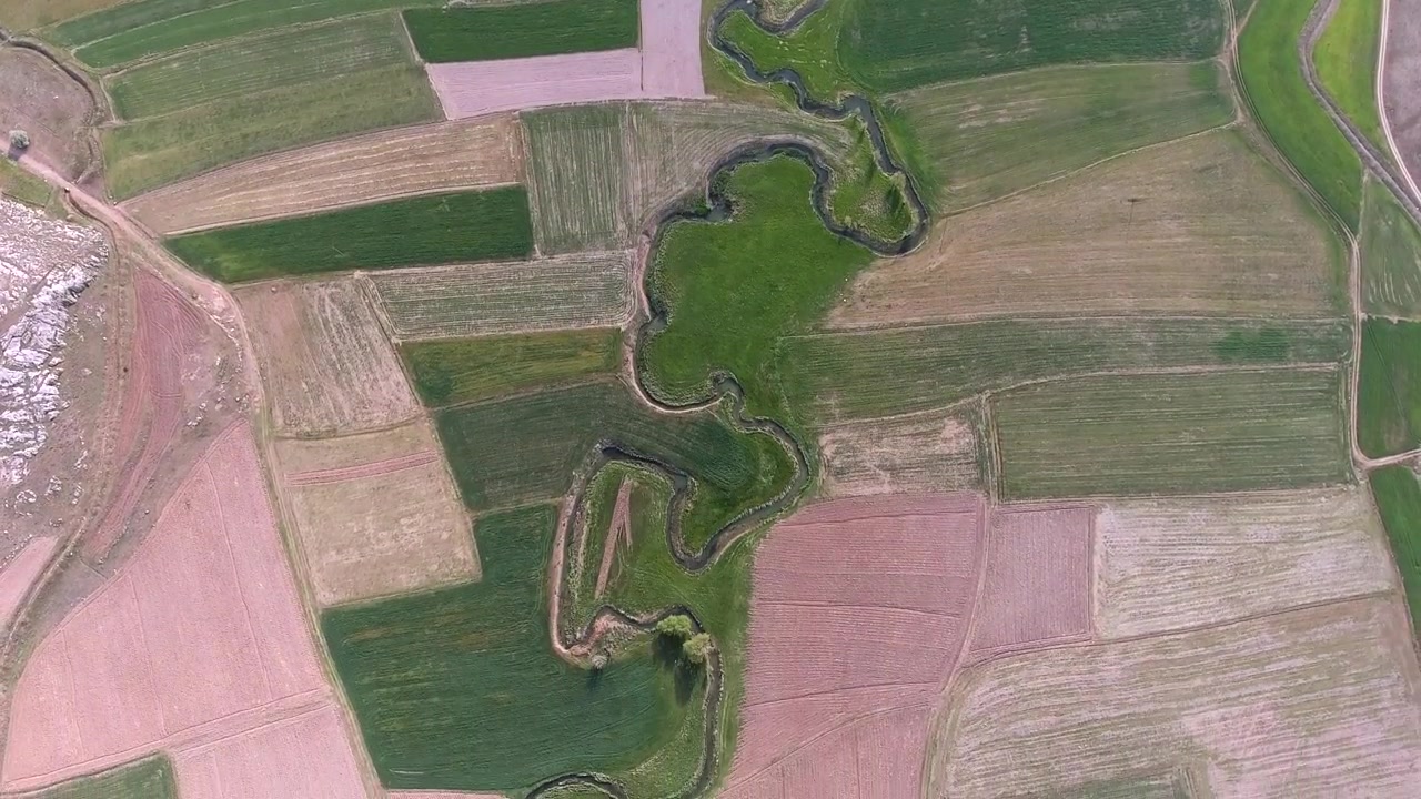 Aerial View of Meandering River Through Agricultural Fields