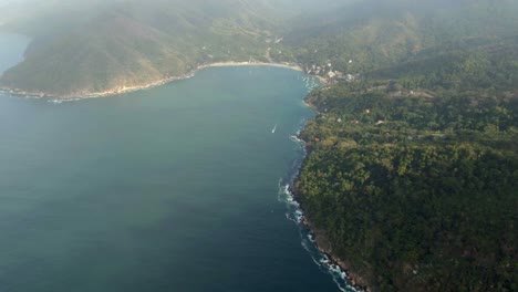 revealed secluded beach surrounded with rainforest mountains at yelapa beach in jalisco, mexico