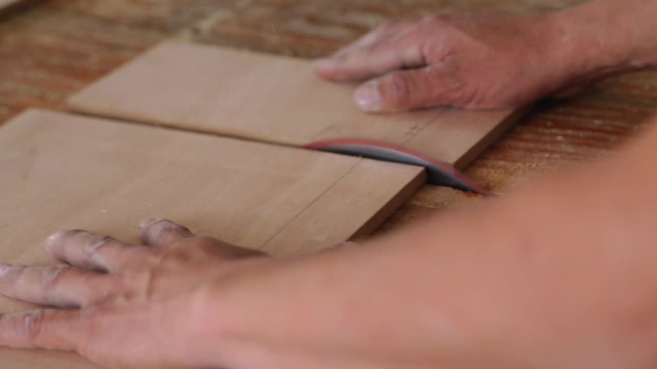 Carpenter cutting a wooden table