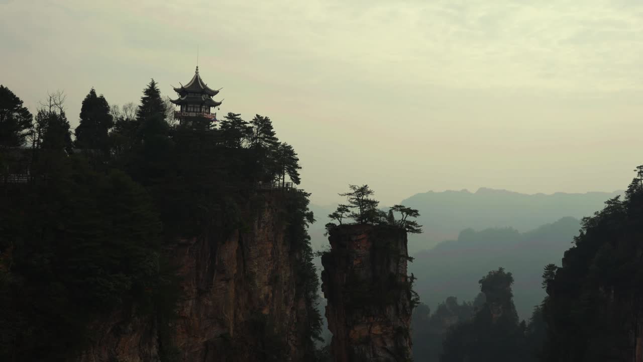 High-Angle View of a Temple Pavilion Overlooking the Misty Avatar Mountains Landscape of China