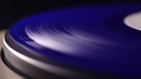 close up, blue vinyl record spinning on gramophone turntable