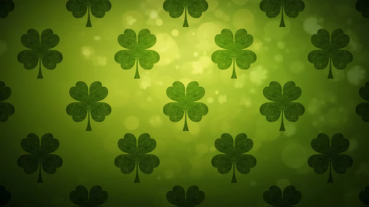 Looping grid of four-leaf clovers drifting upward on green backdrop with bokeh, creating glow loop