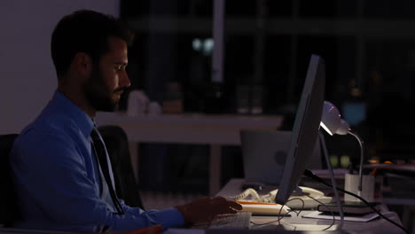 animation of infographic interface and focused caucasian businessman working over computer in office