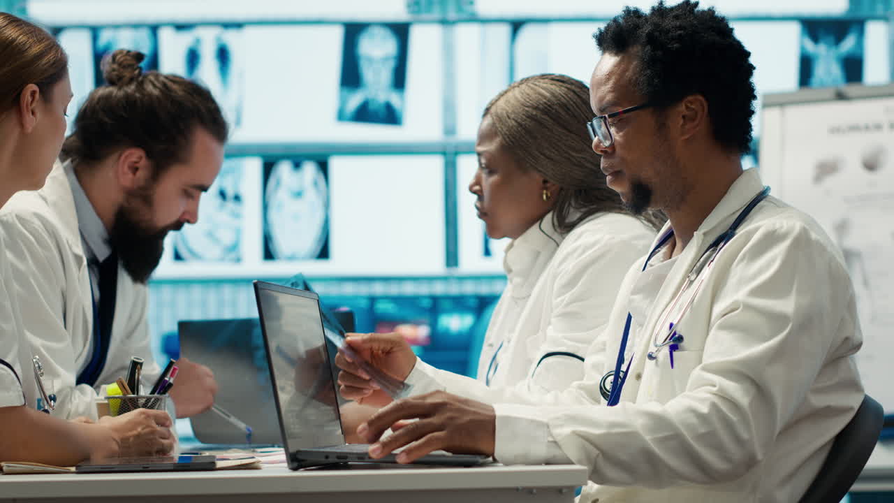 Medical team meeting and working on laptops