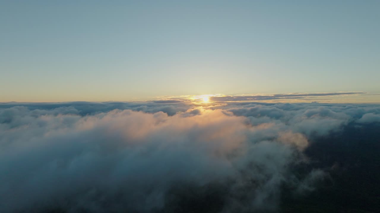 Aerial drone slow motion fly above the clouds with sun raising background, Japanese sunrise in Hokkaido