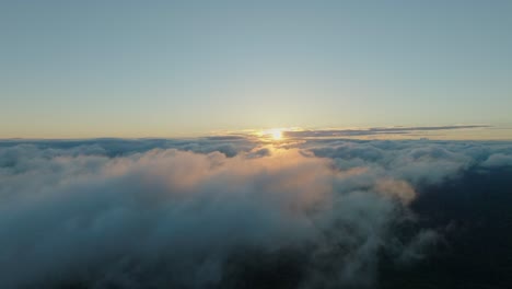 aerial drone slow motion fly above the clouds with sun raising background, japanese sunrise in hokkaido
