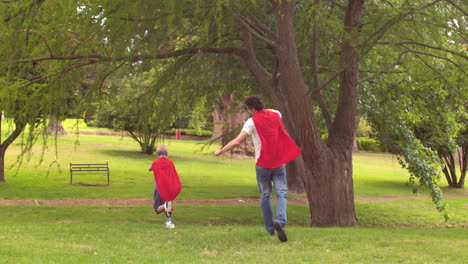 father and son pretending to be superhero