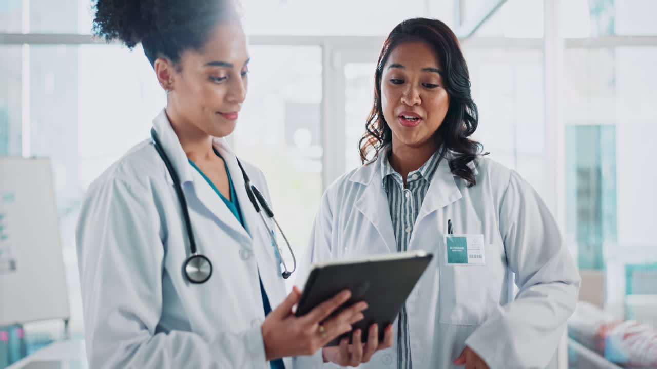 Doctors discussing patient information on a tablet