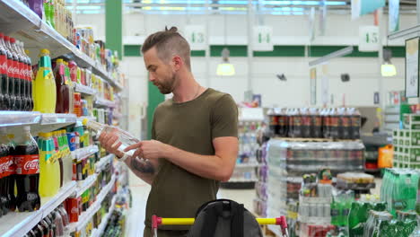 man shopping for drinks in a supermarket