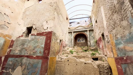 A-haunting-corridor-in-Pompeii-with-well-preserved-ancient-frescoes-depicting-Roman-life,-evoking-the-rich-cultural-history-of-this-once-bustling-city