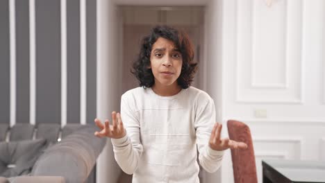 frustrated indian kid asking questions to someone