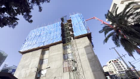 bomba de hormigón de gran altura en uso en addis abeba, etiopía con andamios de palo en uso