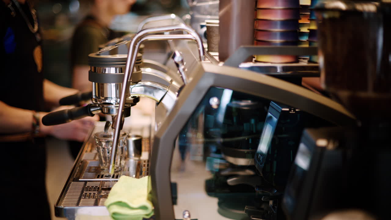 Barista working near a coffee machine at a cafe