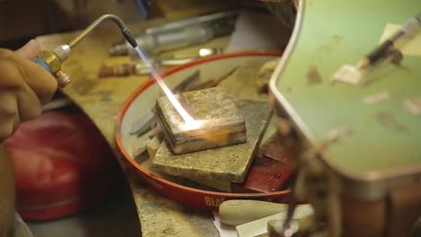 italian goldsmith at work building an engagement or a wedding ring