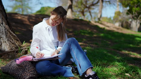 student studying outdoors in park