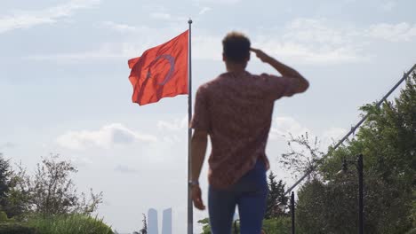 man walking saluting the turkish flag.