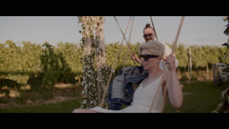 couple swinging in a vineyard