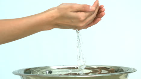 woman washing her hands in a sink