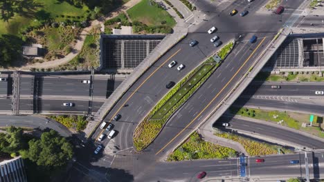 aerial birds eye view of traffic driving over avenue vitcaura overpass in santiago