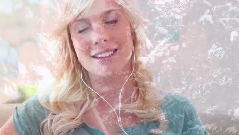 Animation-of-smiling-woman-wearing-earphones-listening-to-music,-over-trees-in-sunshine