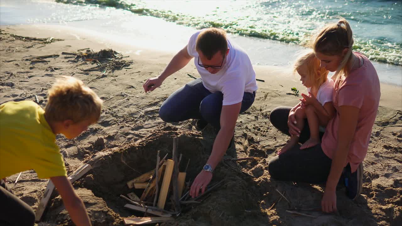 Family enjoying a campfire on the beach