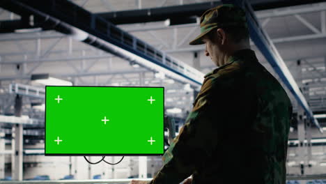 military data center professional using software on green screen mockup pc