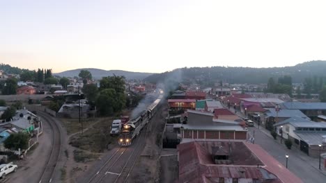 Aerial-rolling-drone-shot-of-the-El-Chepe-passenger-train-in-Creel,-Chihuahua,-Mexico