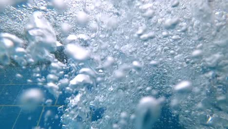 underwater, bubble pool, water raising towards surface, close up