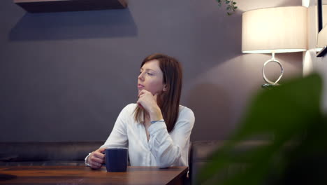 attractive young woman in a cafe drinking coffee