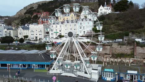 llandudno pier victorian promenade ferris wheel attraction and grand hotel resort aerial view push in left