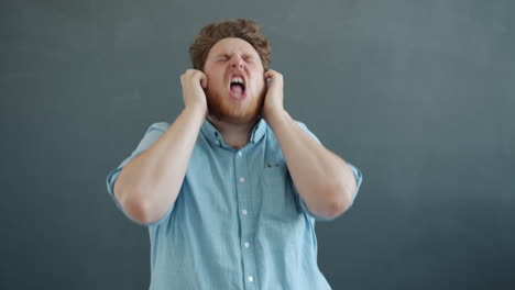 man singing along to music with headphones